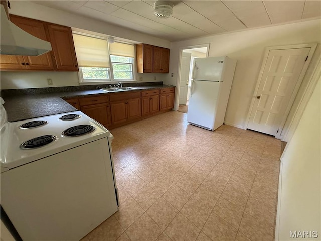 418 Monroe St, Pacific, MO 63069 - kitchen with white appliances, exhaust hood, dark countertops, brown cabinetry, and light floors