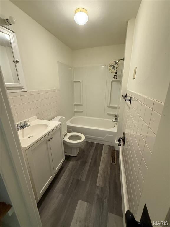418 Monroe St, Pacific, MO 63069 - bathroom with tile walls, vanity, wood finished floors, bathing tub / shower combination, and wainscoting