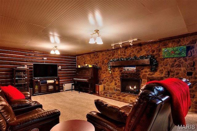 1369 County Highway 408, Benton, MO 63736 - carpeted living area with a stone fireplace, rail lighting, and log walls