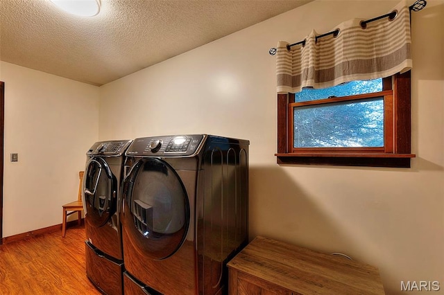 1369 County Highway 408, Benton, MO 63736 - washroom with washing machine and dryer, wood finished floors, and a textured ceiling