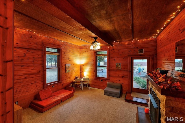1369 County Highway 408, Benton, MO 63736 - carpeted living area with a stone fireplace, wooden walls, ceiling fan, and wooden ceiling
