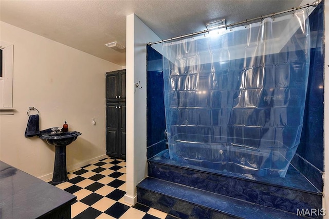 1369 County Highway 408, Benton, MO 63736 - full bath with tile patterned floors, shower / tub combo with curtain, and a textured ceiling