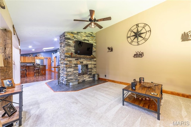 317 Johnson Pl, Palmyra, MO 63461 - carpeted living room featuring vaulted ceiling, a ceiling fan, a fireplace, and bar area