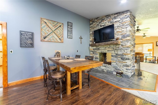 317 Johnson Pl, Palmyra, MO 63461 - dining area with wood finished floors, a ceiling fan, and a fireplace