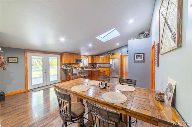 317 Johnson Pl, Palmyra, MO 63461 - dining space with a skylight, vaulted ceiling, and light wood finished floors