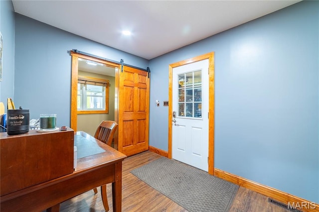317 Johnson Pl, Palmyra, MO 63461 - home office with a barn door, wood finished floors, and recessed lighting
