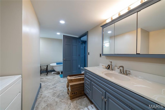 317 Johnson Pl, Palmyra, MO 63461 - full bath with washer / clothes dryer, vanity, recessed lighting, a freestanding tub, and tile patterned floors