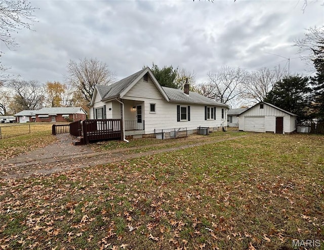 9758 Diamond Dr, Riverview, MO 63137 - rear view of house featuring a chimney, a garage, an outbuilding, a deck, and a shingled roof