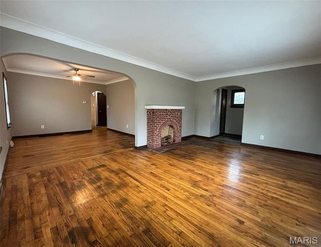 9758 Diamond Dr, Riverview, MO 63137 - unfurnished living room featuring wood finished floors, a brick fireplace, ceiling fan, and ornamental molding