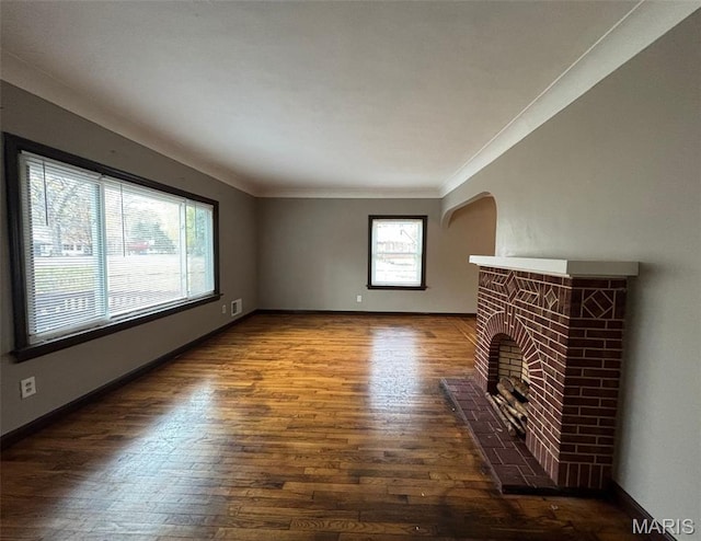 9758 Diamond Dr, Riverview, MO 63137 - unfurnished living room with hardwood / wood-style flooring, a brick fireplace, and ornamental molding