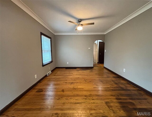 9758 Diamond Dr, Riverview, MO 63137 - spare room with arched walkways, ornamental molding, wood finished floors, and ceiling fan
