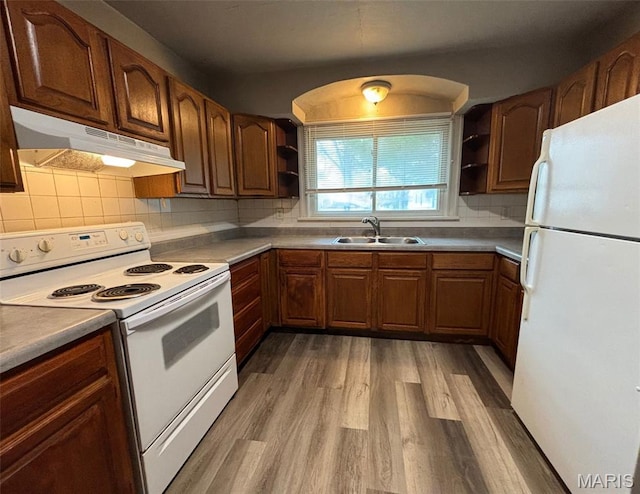 9758 Diamond Dr, Riverview, MO 63137 - kitchen with white appliances, open shelves, under cabinet range hood, wood finished floors, and decorative backsplash
