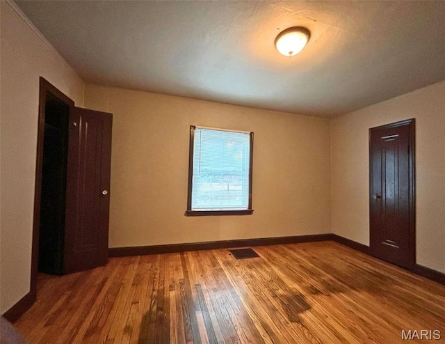 9758 Diamond Dr, Riverview, MO 63137 - unfurnished bedroom featuring hardwood / wood-style floors and baseboards