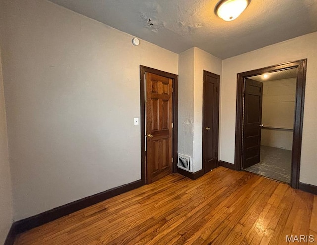 9758 Diamond Dr, Riverview, MO 63137 - unfurnished bedroom with wood-type flooring and a closet