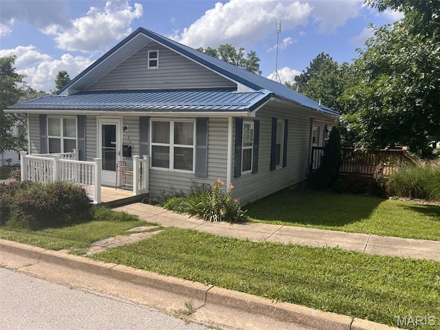 315 E N St, Saint Clair, MO 63077 - bungalow with a porch, a metal roof, and a front lawn