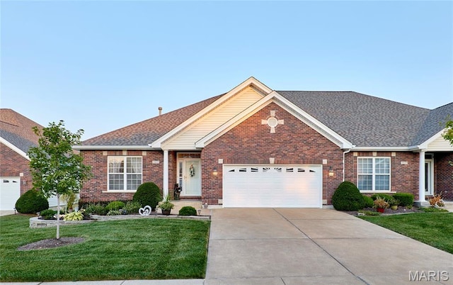 2421 Golden Bear Way Unit 731A, Wentzville, MO 63385 - view of front of home with a garage, concrete driveway, a front yard, and brick siding
