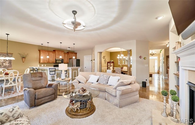 2421 Golden Bear Way Unit 731A, Wentzville, MO 63385 - living room featuring a chandelier, arched walkways, a fireplace, and light tile patterned floors