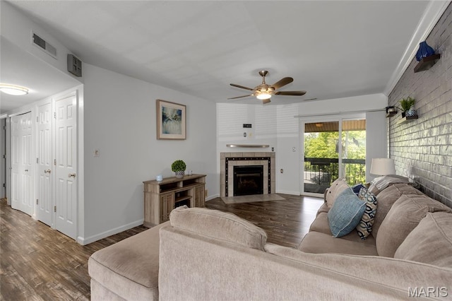 1943 Greenpoint Dr Unit 302, Kirkwood, MO 63122 - living room featuring a tile fireplace, a ceiling fan, and wood finished floors