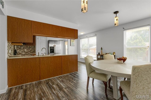 1943 Greenpoint Dr Unit 302, Kirkwood, MO 63122 - kitchen featuring stainless steel fridge with ice dispenser, a peninsula, brown cabinets, and dark wood-style floors