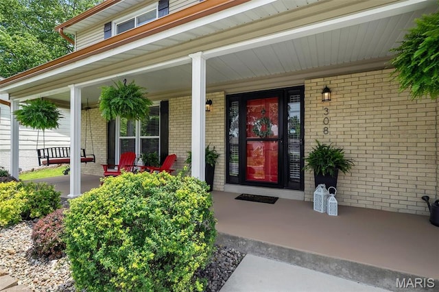 308 Rebecca Dr, Saint Charles, MO 63301 - view of exterior entry with covered porch and brick siding