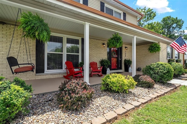 308 Rebecca Dr, Saint Charles, MO 63301 - view of exterior entry with a porch and brick siding