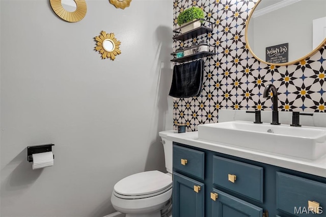 308 Rebecca Dr, Saint Charles, MO 63301 - half bathroom featuring vanity, ornamental molding, and wallpapered walls