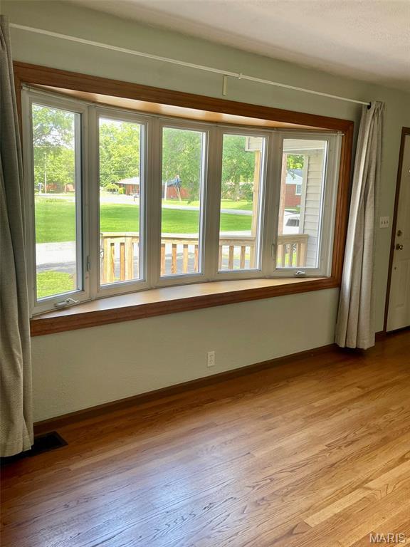 12 Dee, Moro, IL 62067 - unfurnished room with healthy amount of natural light and light wood finished floors