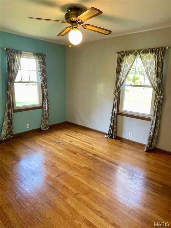 12 Dee, Moro, IL 62067 - unfurnished room featuring healthy amount of natural light, wood finished floors, and a ceiling fan