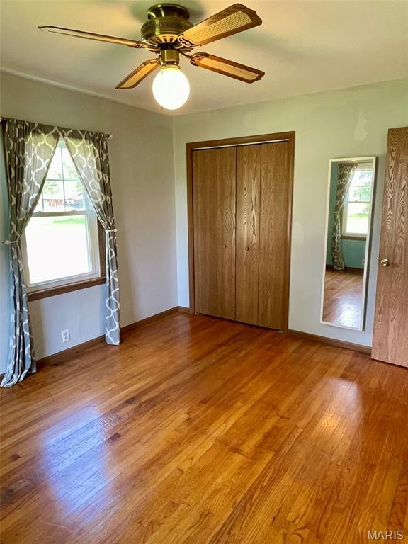 12 Dee, Moro, IL 62067 - unfurnished bedroom featuring wood finished floors, ceiling fan, and a closet