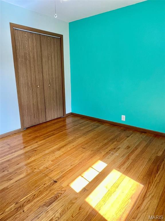 12 Dee, Moro, IL 62067 - unfurnished bedroom with light wood-type flooring and a closet