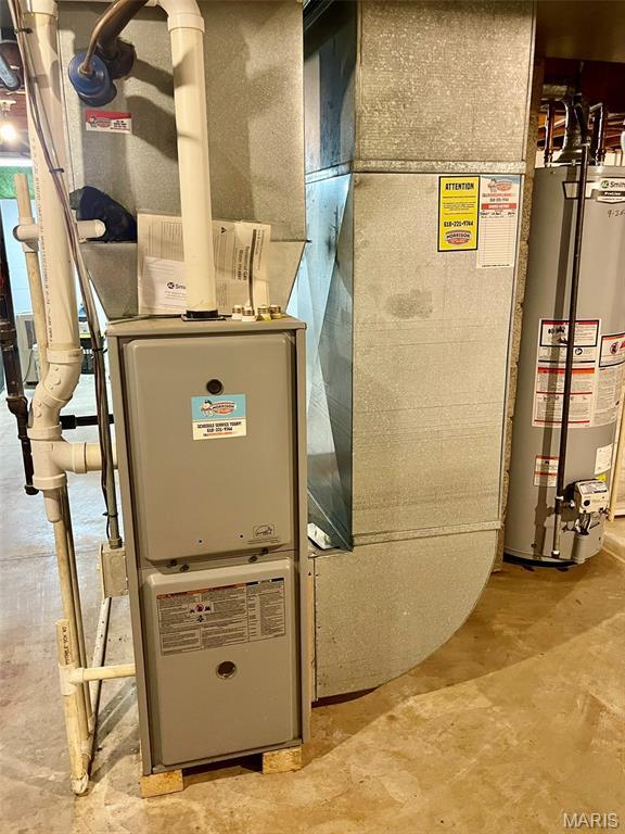 12 Dee, Moro, IL 62067 - utility room featuring gas water heater and heating unit