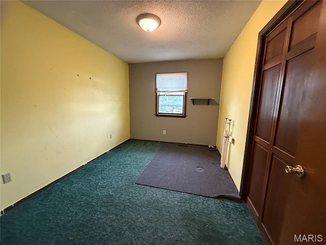 1206 Virginia Ave, Canton, MO 63435 - unfurnished bedroom featuring dark carpet and a textured ceiling