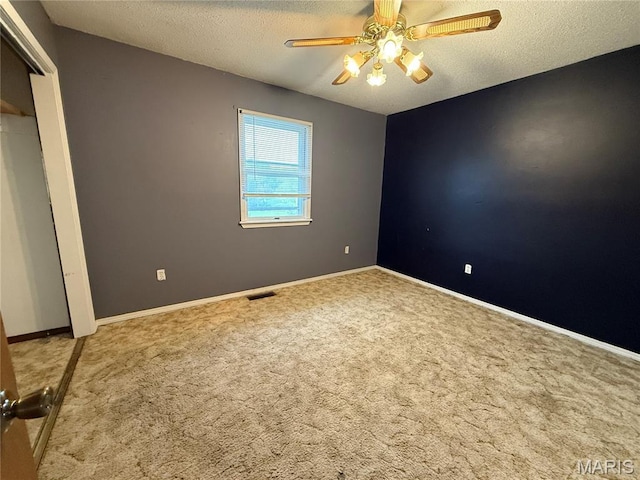 1206 Virginia Ave, Canton, MO 63435 - unfurnished bedroom featuring carpet floors, a textured ceiling, and a ceiling fan