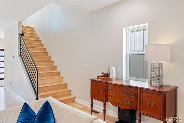 6297 Magnolia Ave, Saint Louis, MO 63139 - staircase featuring baseboards and wood finished floors