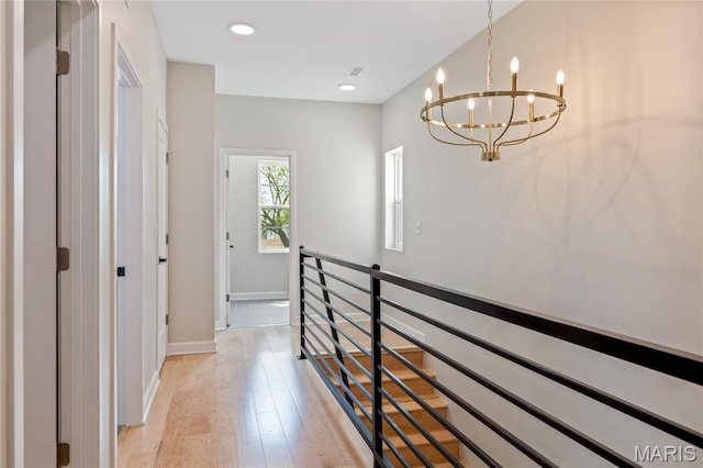 6297 Magnolia Ave, Saint Louis, MO 63139 - corridor with a chandelier, light wood-type flooring, an upstairs landing, and recessed lighting
