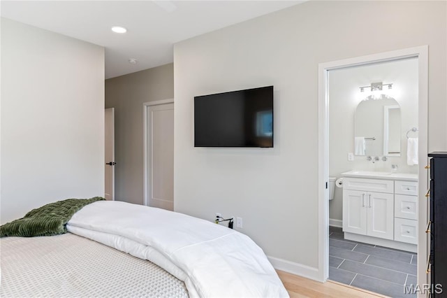 6297 Magnolia Ave, Saint Louis, MO 63139 - bedroom with light wood-style floors and ensuite bath