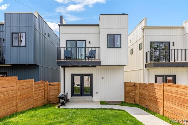 6297 Magnolia Ave, Saint Louis, MO 63139 - rear view of house featuring a balcony, a fenced backyard, and french doors