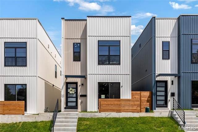 6297 Magnolia Ave, Saint Louis, MO 63139 - modern farmhouse style home featuring stairway and board and batten siding