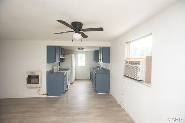 15 S 13th St, Wood River, IL 62095 - kitchen with heating unit, white appliances, blue cabinets, a ceiling fan, and light wood finished floors