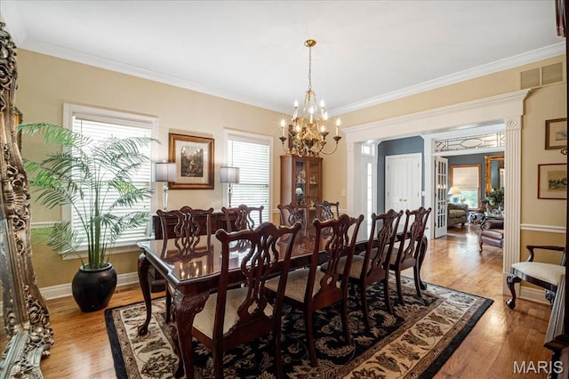 2175 Oberhelman Rd, Foristell, MO 63348 - dining room featuring a chandelier, healthy amount of natural light, ornamental molding, and light wood-style flooring