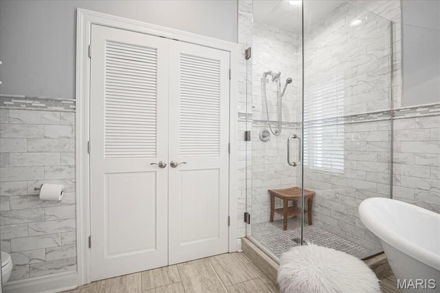 2175 Oberhelman Rd, Foristell, MO 63348 - full bathroom with tile walls, a stall shower, and a freestanding tub