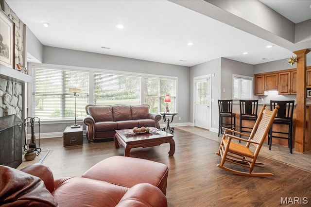 2175 Oberhelman Rd, Foristell, MO 63348 - living room with plenty of natural light, a stone fireplace, wood finished floors, and recessed lighting