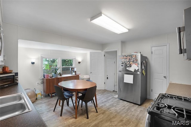 10502 Kamping Ln, Saint Louis, MO 63123 - kitchen with appliances with stainless steel finishes and light wood finished floors