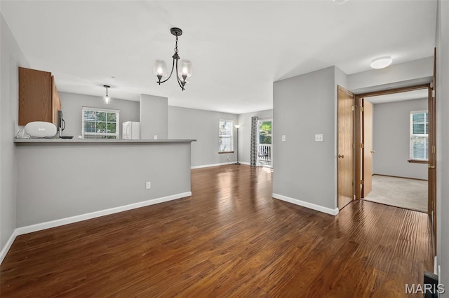 1141 Arbor Creek Dr Unit 2C, Saint Louis, MO 63122 - unfurnished living room featuring dark wood-type flooring, a chandelier, and plenty of natural light