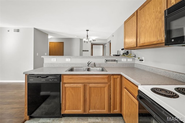 1141 Arbor Creek Dr Unit 2C, Saint Louis, MO 63122 - kitchen featuring black appliances, a chandelier, a peninsula, and light countertops
