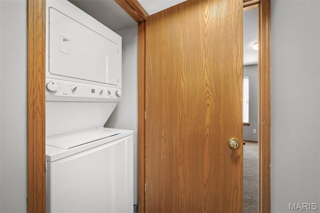 1141 Arbor Creek Dr Unit 2C, Saint Louis, MO 63122 - washroom featuring stacked washer / drying machine and carpet floors