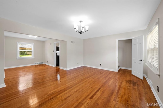 841 N Geyer Rd, Kirkwood, MO 63122 - unfurnished room with a chandelier and light wood-style flooring