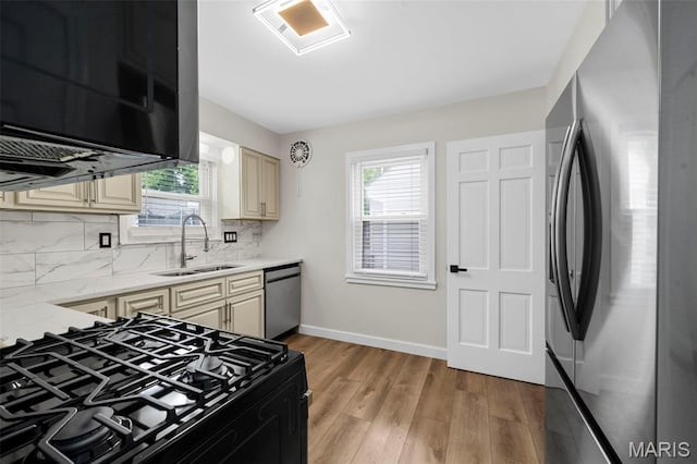 841 N Geyer Rd, Kirkwood, MO 63122 - kitchen featuring appliances with stainless steel finishes, cream cabinetry, tasteful backsplash, and light wood finished floors