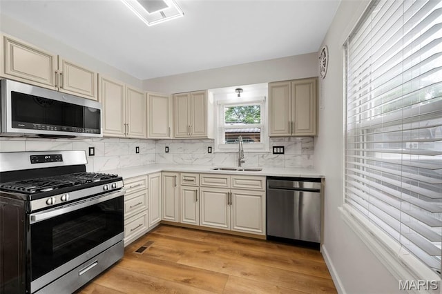 841 N Geyer Rd, Kirkwood, MO 63122 - kitchen featuring stainless steel appliances, cream cabinets, and decorative backsplash
