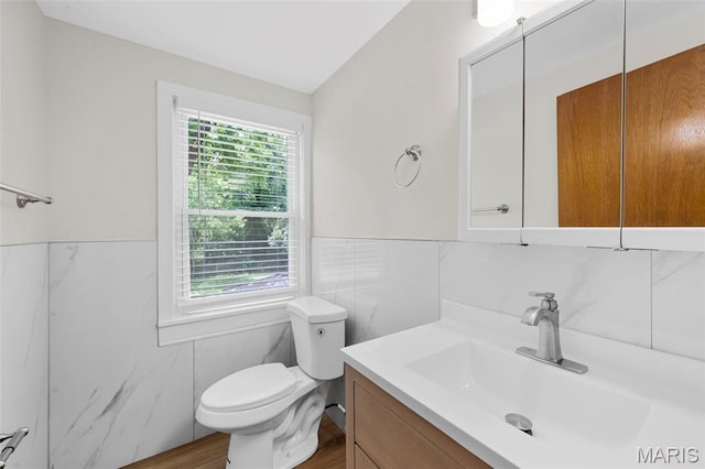 841 N Geyer Rd, Kirkwood, MO 63122 - bathroom featuring tile walls, vanity, wood finished floors, and wainscoting